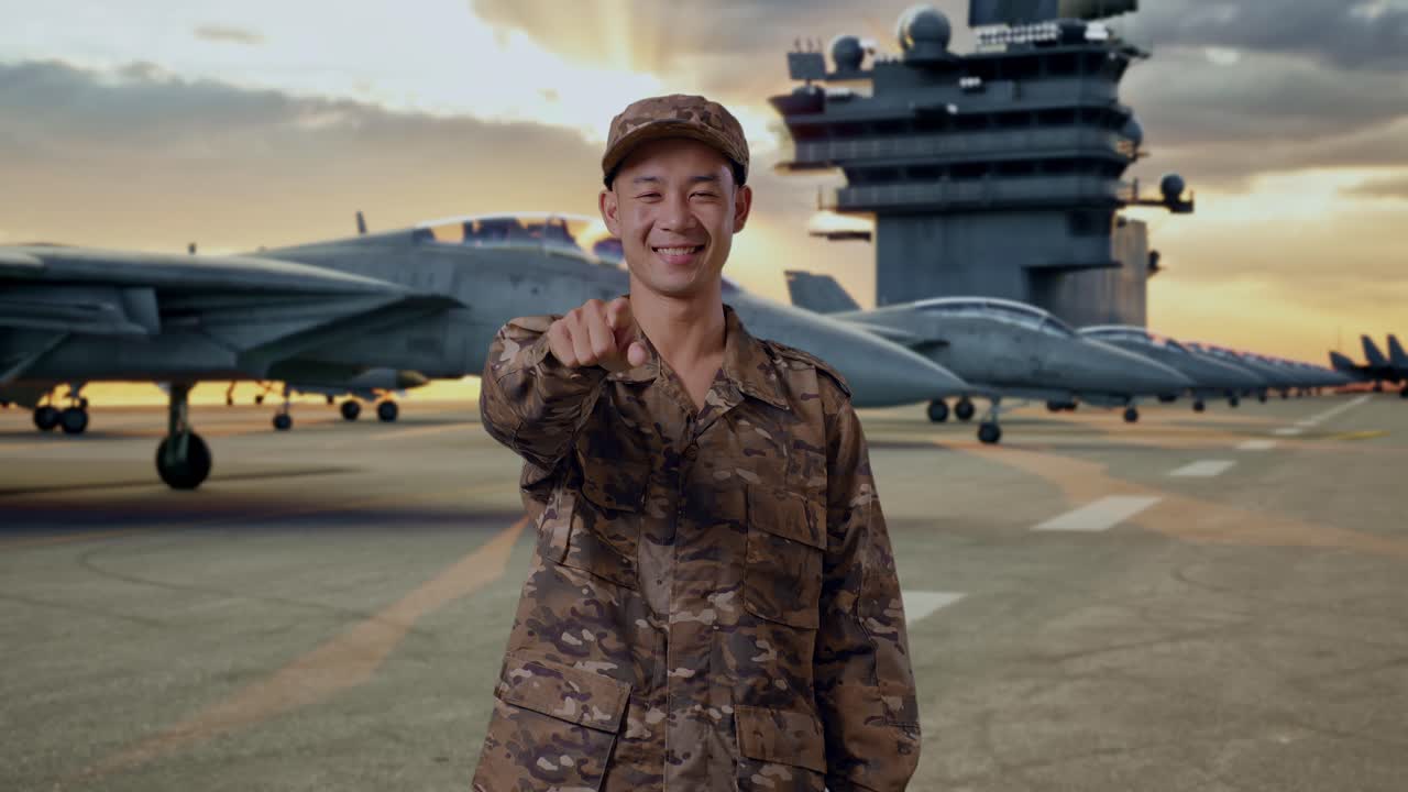 Military Personnel Pointing at Camera on Aircraft Carrier Deck at Sunset