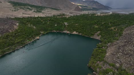 Beautiful-landscape-of-water-lake-green-lush-trees-forest-and-rocky-mountains-in-Pakistan