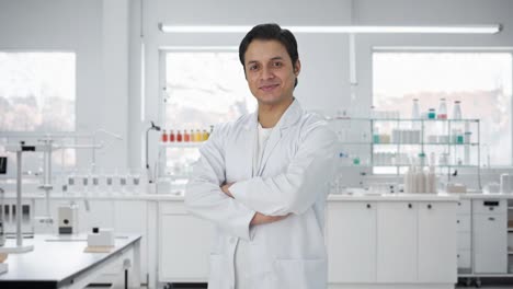 portrait of happy indian scientist standing crossed hands