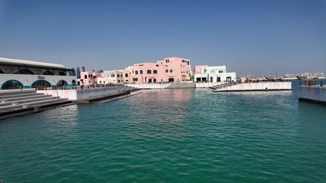 waterfront promenade with colorful buildings and turquoise water