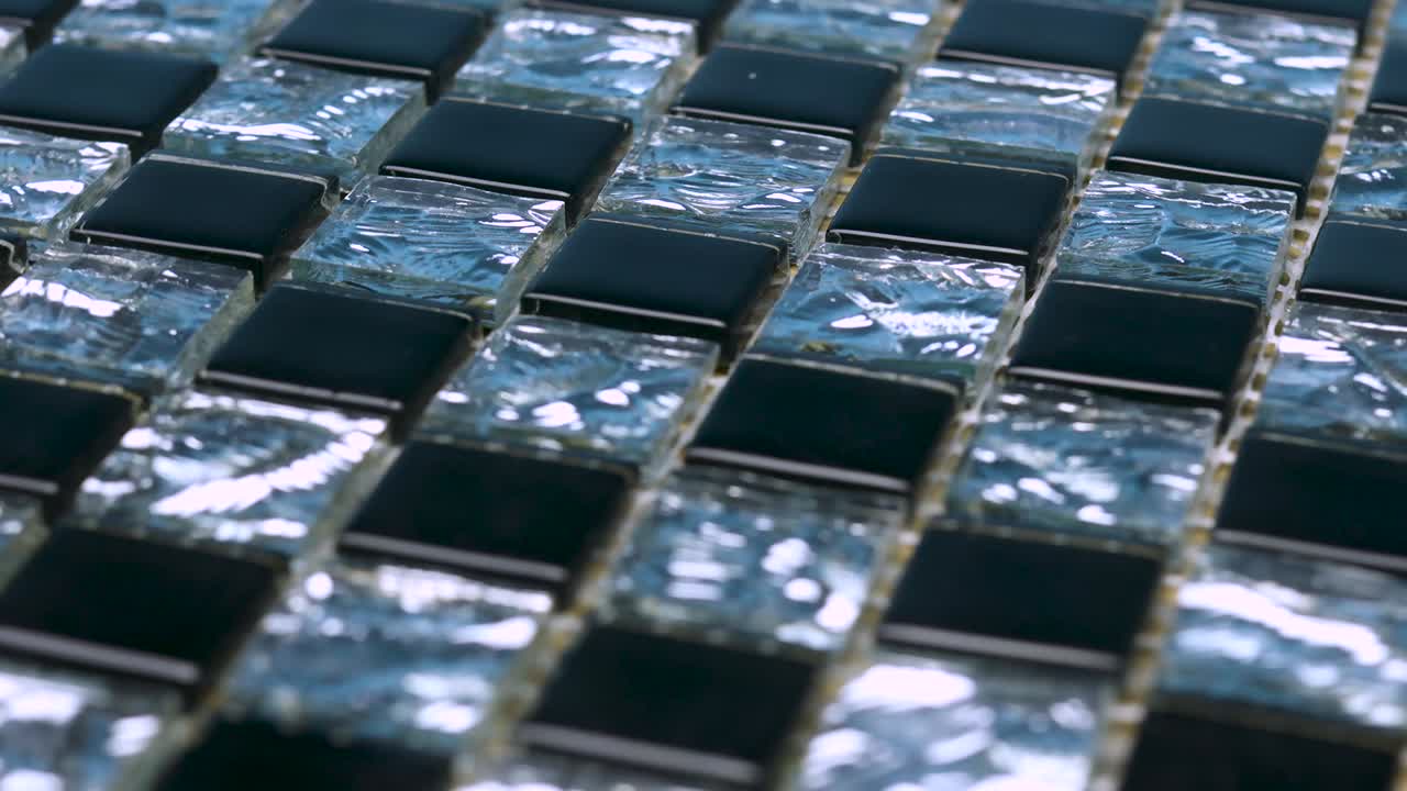 The black-and-white mosaic turns in a circle.