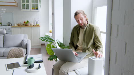 Man-sitting-on-the-windowsill