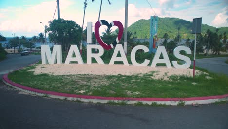 me encanta el cartel de maracas con cielos soleados en el fondo en trinidad