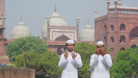 two muslim men offering namaz at jama masjid india