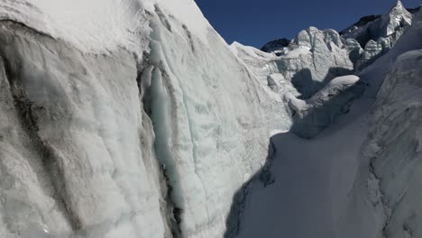 icy facade in a glacier on a swiss alps high altitude mountain, aerial view