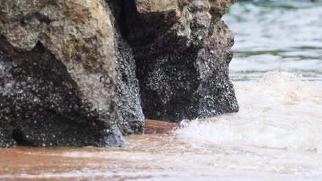 waves hitting rocks at ao nang beach