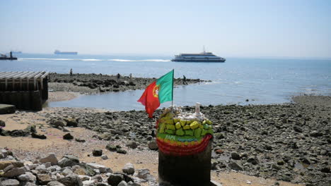 portugal flag in front of the sea in lisboa waving in the wind