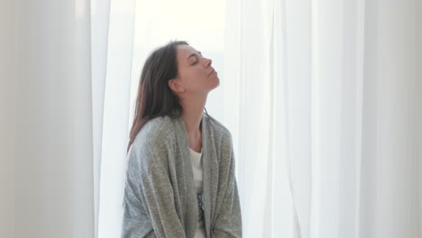 Woman-With-Closed-Eyes-Deeply-Breathing-At-Home-In-The-Morning