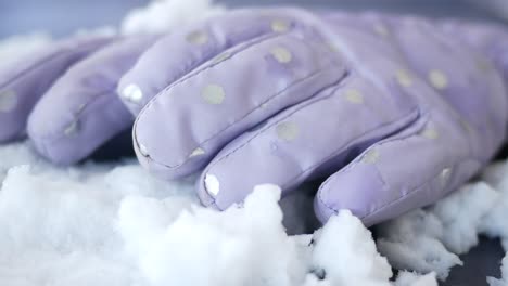 purple polka dot gloves in snow