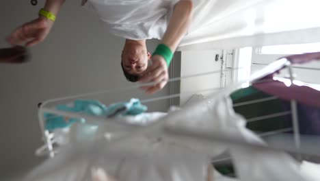 man hanging clothes