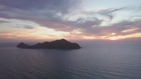 Beautiful-view-of-small-island-in-ocean-at-sunset