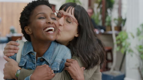 portrait of young woman suprise embracing friend diverse girlfriends kiss hugging laughing enjoying friendship hang out together in urban background togetherness