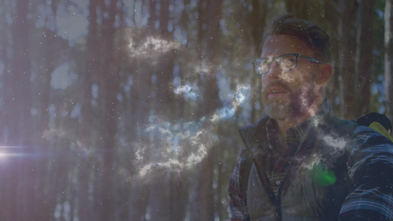 man lifting sheet and revealing glowing nebula ribbon in forest technology demonstration