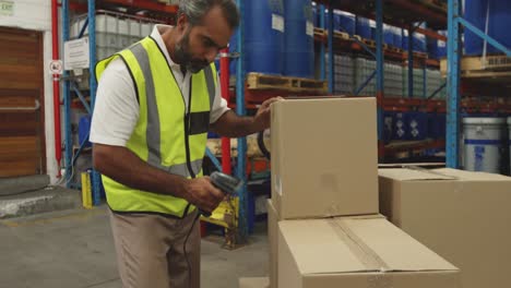 male worker using barcode scanner in a warehouse