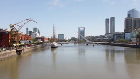 Aerial-view-down-Puerto-Madero-downtown-urban-waterfront-river-district-buildings-cityscape-low-angle