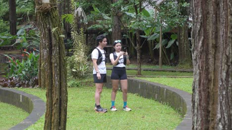 indonesian young adults using smartphone during trail run in forest