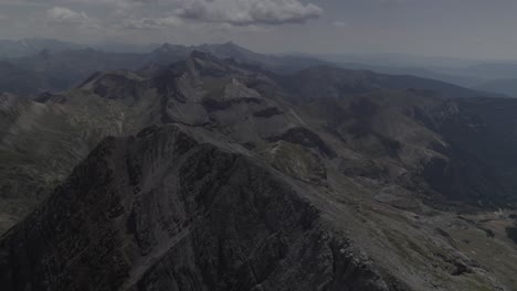 this drone video captures a stunning orbit shot around the majestic pico bisaurín in the aragonese pyrenees, spain, showcasing its rugged peaks and breathtaking mountain landscapes.