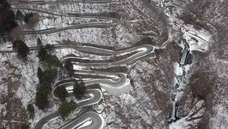 looking down on traffic moving along the wintery irohazaka winding road, nikko, tochigi, japan