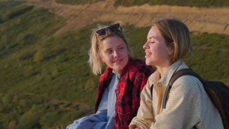 two friends enjoying the view from the mountaintop