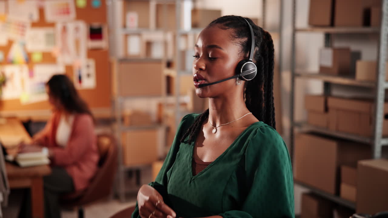 Professional Woman in Headset Communicating in Small Business Office
