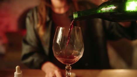 Woman-putting-red-wine-into-glass-slowmotion