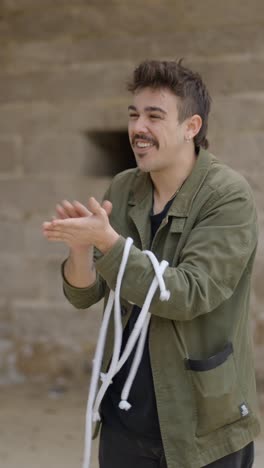 man demonstrating a rope magic trick