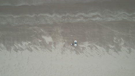 rising drone car parked on inch beach dingle peninsula ireland overhead drone aerial view