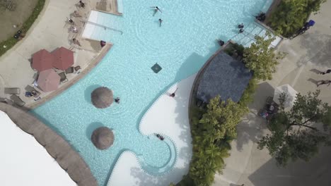 aerial view of a resort pool with people relaxing