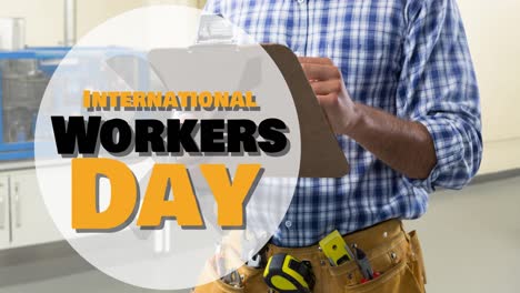 Animation-of-international-workers-day-text-over-caucasian-male-worker-with-clipboard