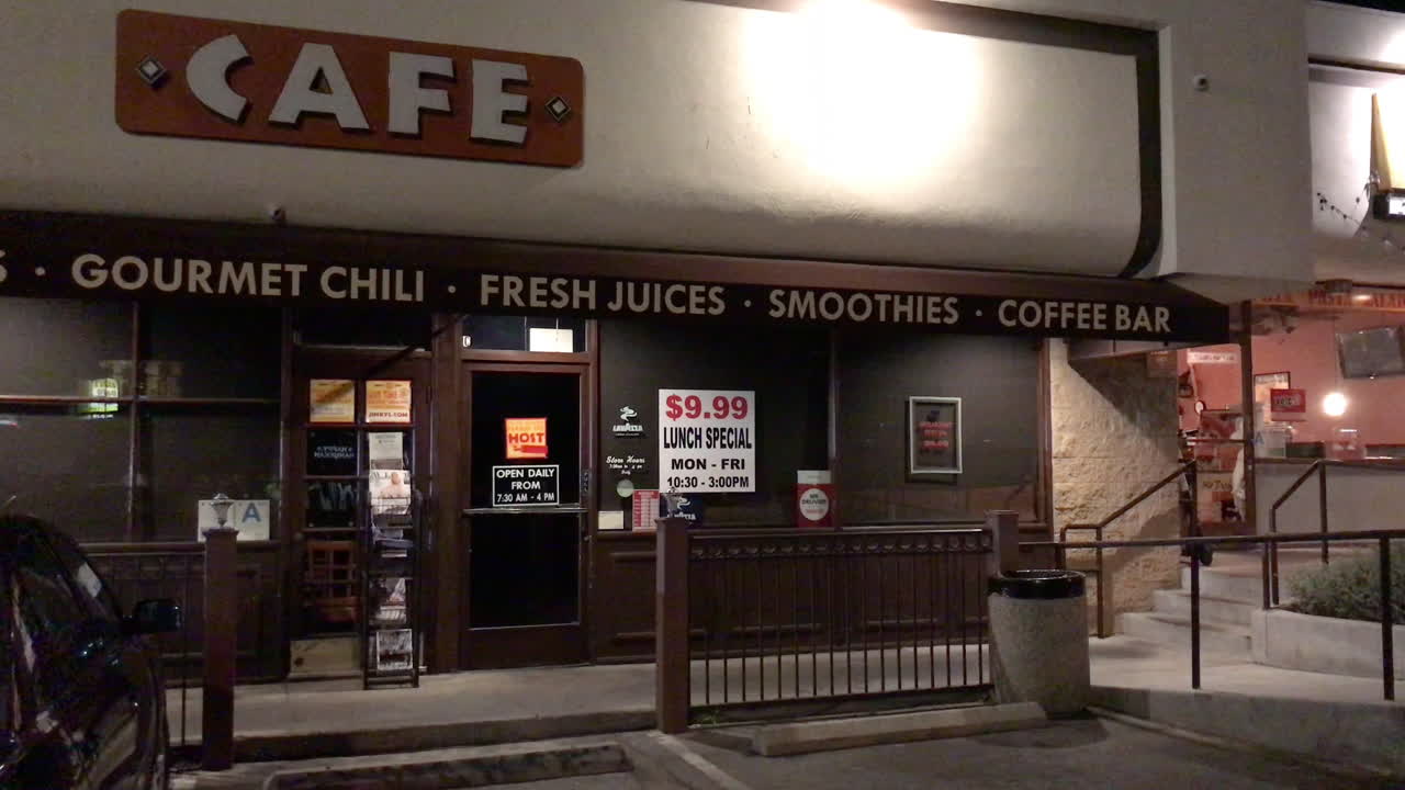 Cafe sign flickers out front at night