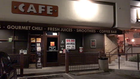cafe sign flickers out front at night