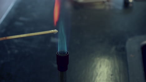 close up of attempted flame test of clacium ions with too much water on the splint