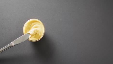 Video-of-close-up-of-peanut-butter-on-gray-background