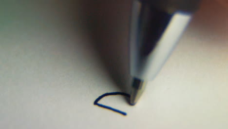 Macro slow motion shot of a pen writing &amp;quot;DEBT