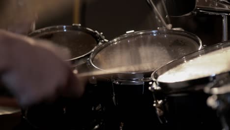 a drummer hitting toms, playing a beat