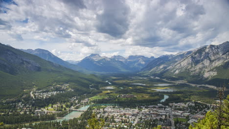 Timelapse-of-Clouds-and-Shadows-Flying-Over-Untouched-Wilderness-Valley-and-Mountain-Town