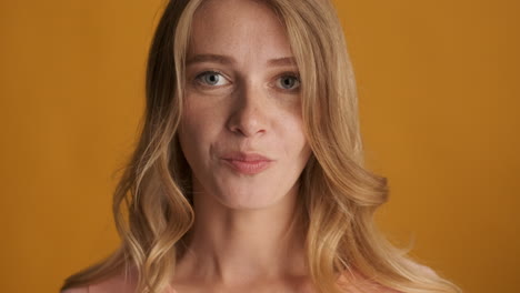 Caucasian woman chewing gum on camera.