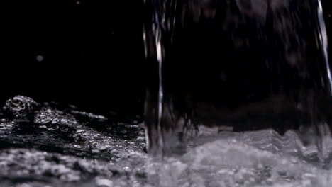 Sheet-of-hot,-steamy-Water-pouring-into-black-background-waterfall-filling-up
