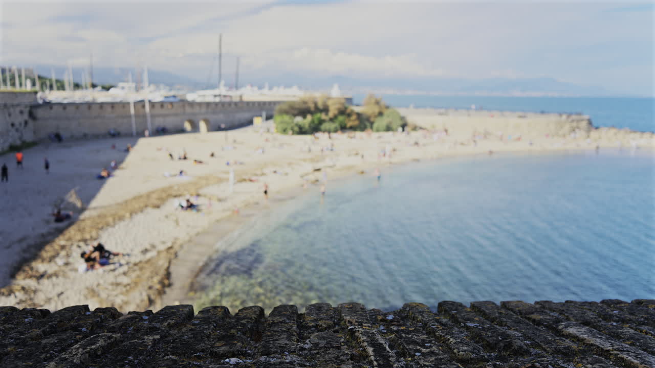 Blurred view of people on the Gravette Beach in Antibes, France