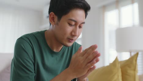asian man sitting at sofa thoughtful fatigue looking away at home.