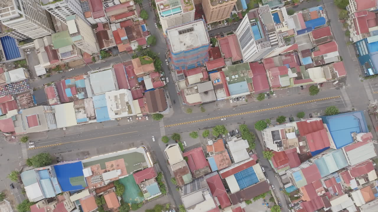 Top-down aerial of Phnom Penh’s city blocks showing a mix of rooftops, streets, and buildings