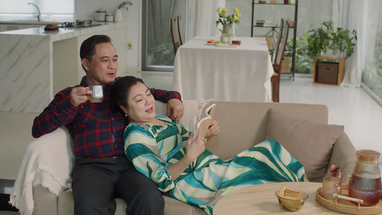 Asian Spouses Resting on Couch on Weekend at Home