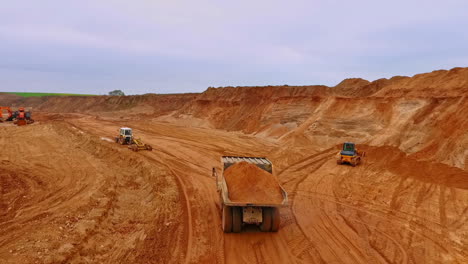 dumper truck transporting sand in quarry. aerial view of sand work