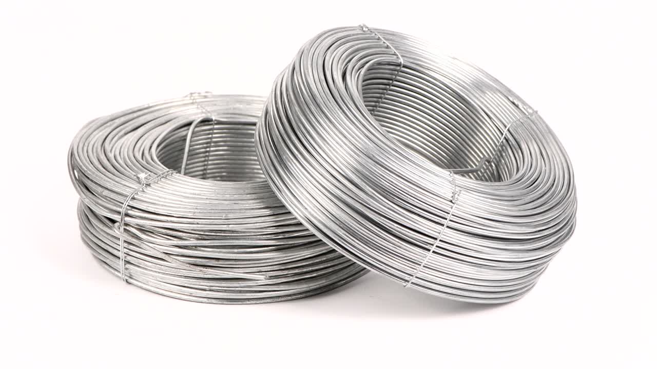 Thick silver wire in coil. Stainless steel wire coil. Loop motion.