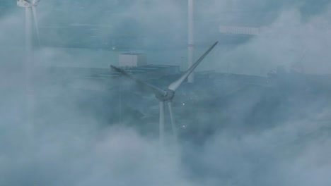 mysterious drone shot through mist over port of vlissingen of wind turbine