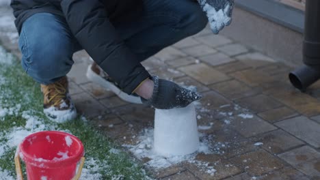 grandfather and granddaughter having fun in the snow