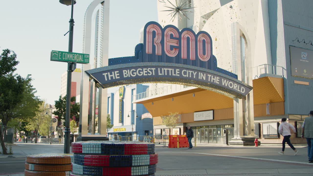 Downtown Reno, Nevada, features large poker chips in the foreground, with the iconic Reno sign prominently displayed in the background, capturing the vibrant essence of the city's gaming culture.