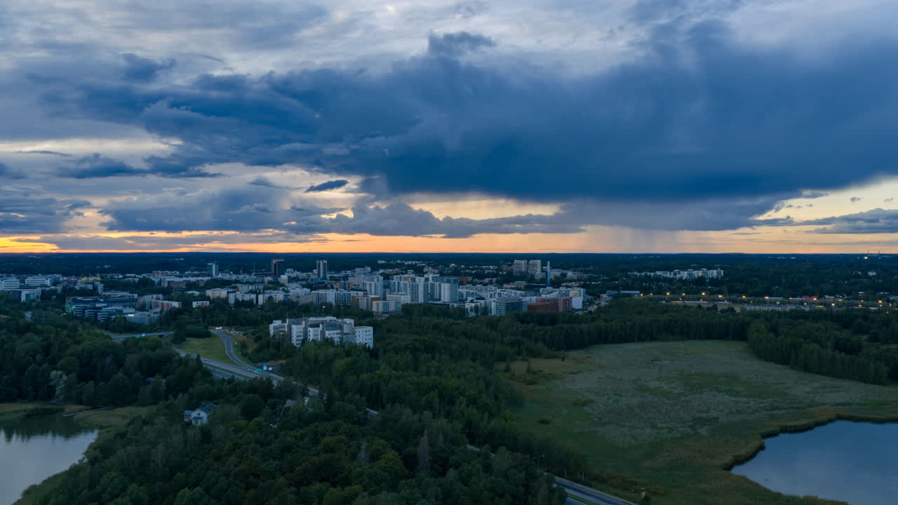 Aerial hyperlapse of dusk clouds rolling over Leppavaara and Laajalahti, Espoo