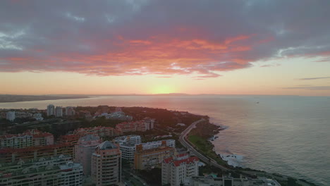 vivid sundown shining ocean horizon over  calm coastal town aerial view