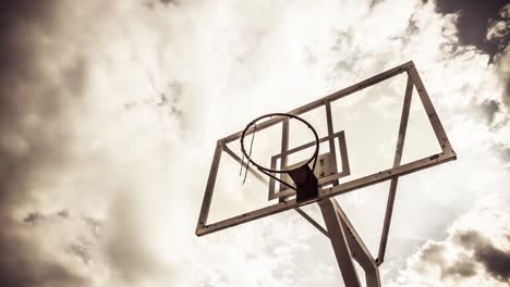 dramatically moving cloud background of a basketball ring in warm color